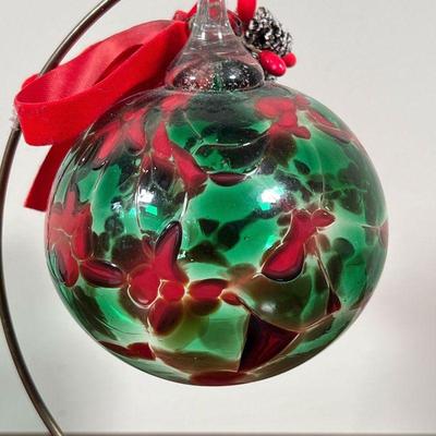 BLOWN GLASS CHRISTMAS ORNAMENT | On a hanging display stand, red and green blown glass, - h. 5 in. (ornament)