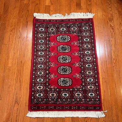 BOKHARA MAT | With five central medallions within a flower border, on a red ground - 3 ft. 2 in. x 2 ft. 2 in.