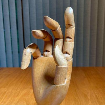 CARVED WOOD ARTICULATED HAND | Having five articulating fingers and a movable wrist on a weighted base with felt bottom - h. 11 in.