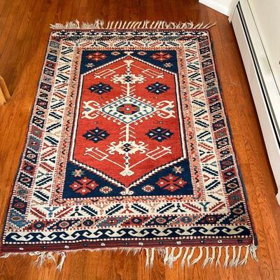 SMALL AREA RUG | With central medallion on a rust field within concentric borders with geometric devices - 5 ft. 5 in. x 3 ft. 9 in.