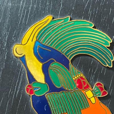 ENAMELED MAYAN HEAD | Colorful enameled Mayan figure mounted on a black painted board, with label on verso - 10-1/4 x 8 in. (overall)