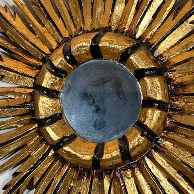 GILT SUNBURST WALL MIRROR | Central round mirror centered by feather form gilt painted carved wood sunburst motif - 16 x 15 in.