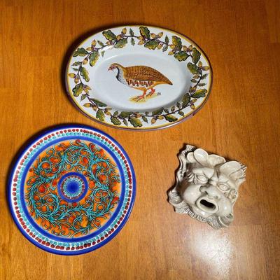(3pc) FAIENCE POTTERY | Including a North Wind form plaque, a painted plate, and a game bird serving dish - l. 12 in. (largest)
