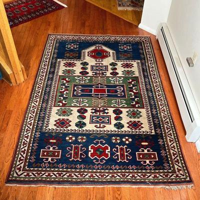 GEOMETRIC AREA RUG | With blue, green, and red geometric devices within concentric geometric borders - 6 ft. 5 in. x 4 ft. 4 in.