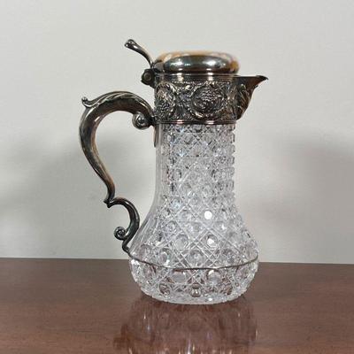 TIFFANY CRYSTAL & SILVER PLATE PITCHER | Tiffany Makers silver soldered lid and handle on a heavy cut crystal pitcher - h. 9-1/2 x w. 7 in.
