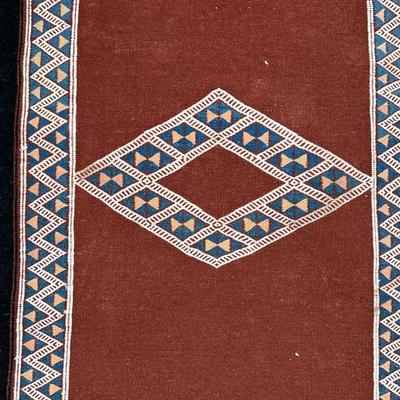 FLAT WOVEN MAT | With a central diamond, and overall diamond and triangle pattern on a brown field - 3 ft. 5 in. x 2 ft.
