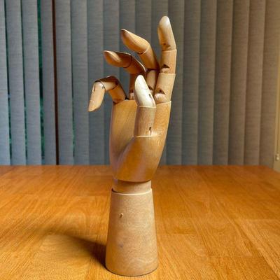 CARVED WOOD ARTICULATED HAND | Having five articulating fingers and a movable wrist on a weighted base with felt bottom - h. 11 in.