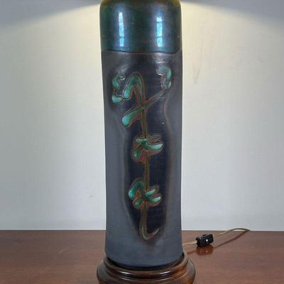 JAPANESE CERAMIC LAMP | Modern Japanese table lamp, of cylindrical form with green glazed characters, mounted on a wood base, with a...
