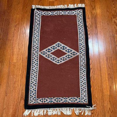 FLAT WOVEN MAT | With a central diamond, and overall diamond and triangle pattern on a brown field - 3 ft. 5 in. x 2 ft.