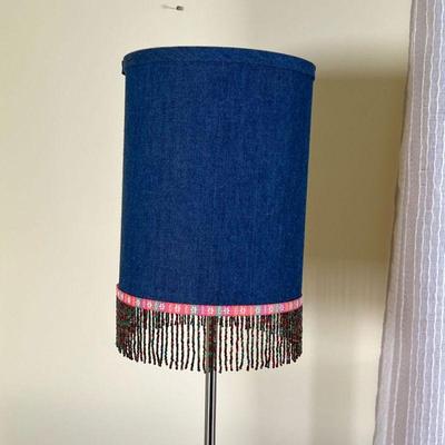 BEADED BEDSIDE LAMP | Small table lamp with beaded tassels hanging from a cylindrical shade, on a metal base - h. 23 in.