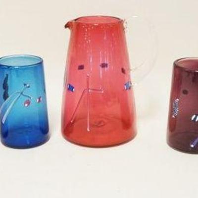 1175	MODERN STYLE GLASS PITCHER W/6 MULTICOLOR TUMBLERS, ARTIST SIGNED, PITCHER IS APPROXIMATELY 7 IN HIGH
