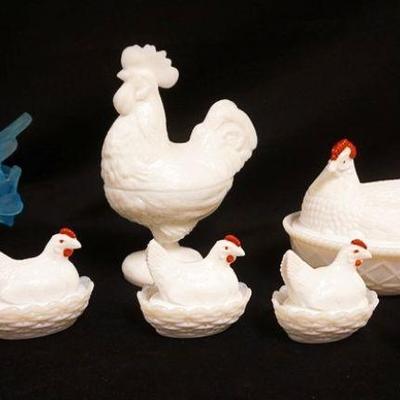 1057	LOT OF MILK GLASS COVERED CHICKEN & ROOSTER & ONE BLUE SATIN GLASS BIRD ON NEST, 7 PIECES, LARGEST IS APPROXIMATELY 9 IN HIGH
