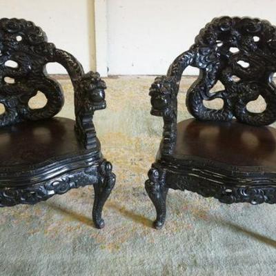 1227	PAIR OF HEAVILY CARVED ASIAN CHAIRS W/DRAGON ARM ENDINGS
