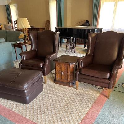 Pair of leather wingback chairs.
