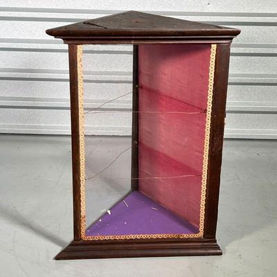 TRIANGULAR CORNER CABINET  |
Small display cabinet with two angled glazed sides and a wood back door; h. 29-1/4 x 21 1/2 x 22 in.