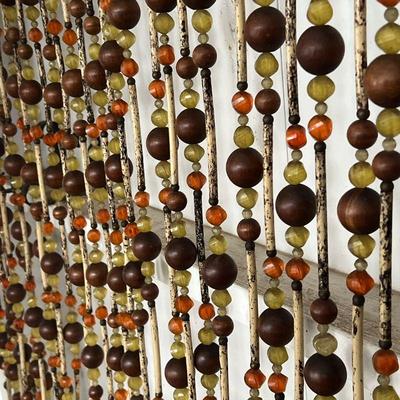 BEADED WALL HANGING  |
With wood beads and amber-type faceted beads hanging from a metal chain - heavy! - w. 72 x h. 58 in.