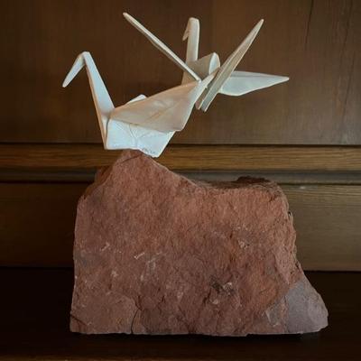 ceramic origami cranes perched on a rock, signed Kevin Box