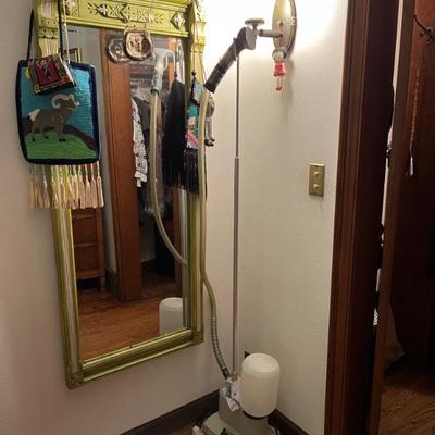 large green wall mirror and clothes steamer