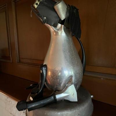 found object sculpture in the shape of a dog, metal kitchen utensils