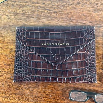 (5pc) MISC. LEATHER ITEMS  |
Including a crocodile photograph case (Smythson London), a miniature blotter, and three pairs of folding...