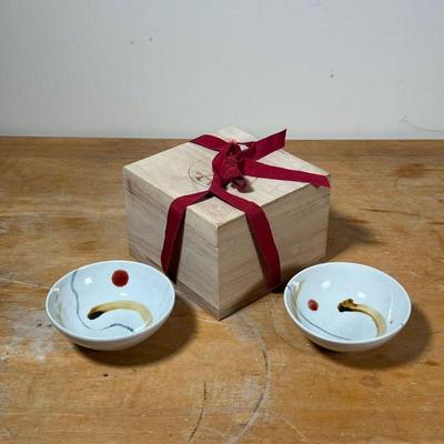 (2pc) PAIR JAPANESE BOWLS  |
Pair Japanese glazed ceramic rice bowls of small size in a lidded wood box, each bowl with impressed stamp...