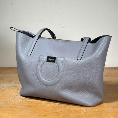 FERRAGAMO LEATHER HANDBAG  |
Salvatore Ferragamo gray leather handbag with suede interior and inner coin purse, still with plastic on the...