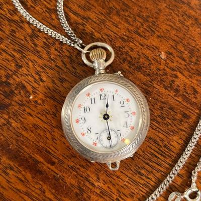 ANTIQUE STERLING POCKET WATCH  |
White face with black enamel Arabic numerals, sub seconds dial, suspended from a chain - dia. 1-1/4 in....