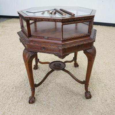 1138	MAHOGANY OCTAGON DISPLAY CABINET ON CARVED STAND W/BALL & CLAW FEET, DOOR IN NEED OF REPAIR, APPROXIMATELY 28 IN X 33 IN HIGH

