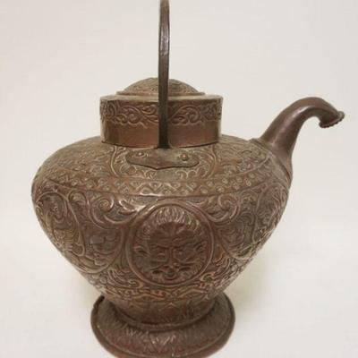 1041	ORNATE HAND TOOLED COPPER PITCHER W/SPOUT & GROSTEQUE FIGURES, TOP LID FINIAL MISSING, APPROXIMATELY 15 IN HIGH
