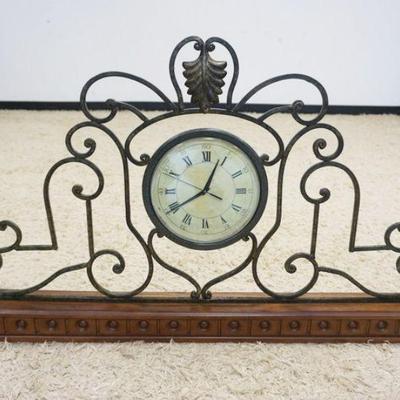 1097	ARCHITECTUAL STYLE IRON MOUNTED ON WOOD BASE W/ QUARTZ CLOCK IN CENTER, APPROXIMATELY 42 IN X 3 1/2 IN X 25 IN HIGH
