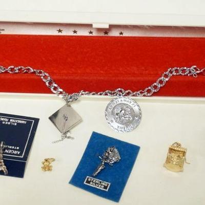 1216	CHARM BRACELET WITH 5 SILVER CHARMS AND  2 14K CHARMS, 14K CHARMS 3.13 DWT
