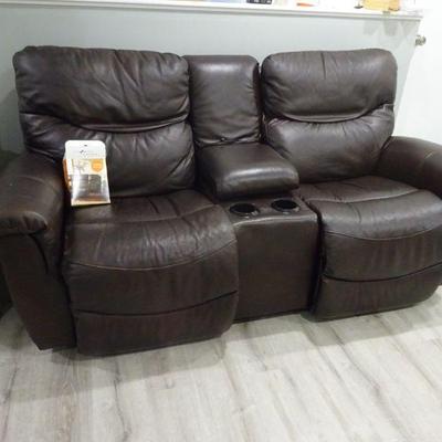 Leather Reclining Loveseat with console and arm rest. Can be used in the movie room or home theatre. 