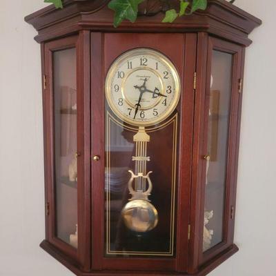 wall clock with two side shelf units, one on each side