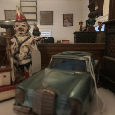 Cast iron clown and tin Mercedes’