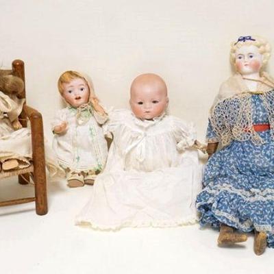 1012	4 SMALLER ANTIQUE SIZE BISQUE HEAD DOLLS, ONE BABY DOLL IS MARKED JAPAN, THE OTHER IS MARKED GERMAN, ONE DOLL IS SEATED ON A WOODEN...