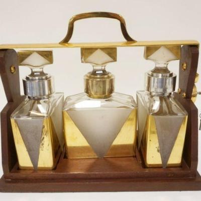 1054	ART DECO 3 BOTTLE DECANTOR SET IN LOCKING WOOD HOLDER, ONE STOPPER W/DAMAGE, APPROXIMATELY 14 1/2 IN X 7 1/4 IN X 12 1/2 IN HIGH
