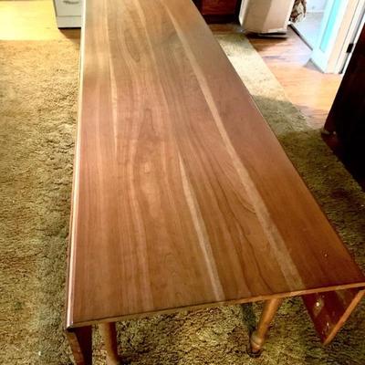 Drop leaf harvest table w/ solid cherry top. 7 ft. long, 24â€ wd. with leaves down, 44â€ w/ leaves up. This table was always covered w/...