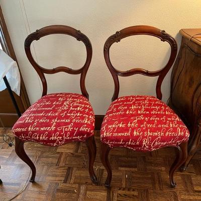 pair of ballooned backed chairs with modern red toile