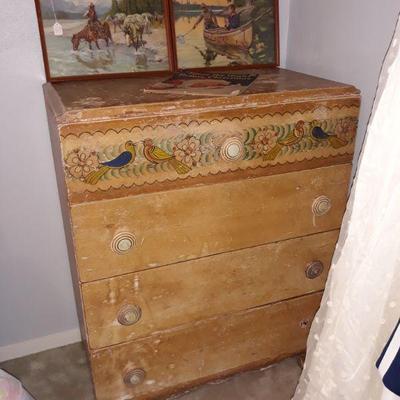 A vintage chest of drawers hand painted