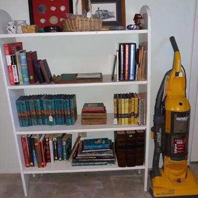 Books, bookshelf, and vacuum 