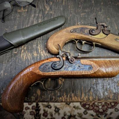 2 Jukar Spain black powder pistols... the smaller one in a .45 cal, and the larger one is a .44