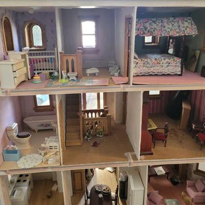 Backside of the doll house showing the interior with furniture