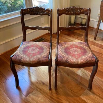 Pair of walnut carved back side chairs.