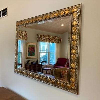 Gold tone mirror measures 51" x 35"