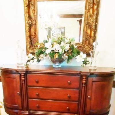 Gorgeous buffet with Elegant heavily gilded mirror and lovely floral arrangement in crystal bowl