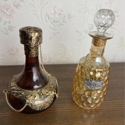 Pair of midcentury decanters, one iridescent amber glass, one brown glass