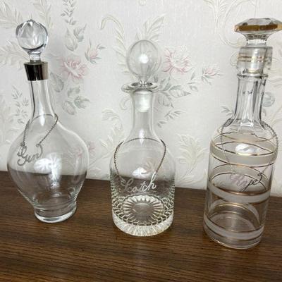 trio of midcentury decanters w/ label necklaces 