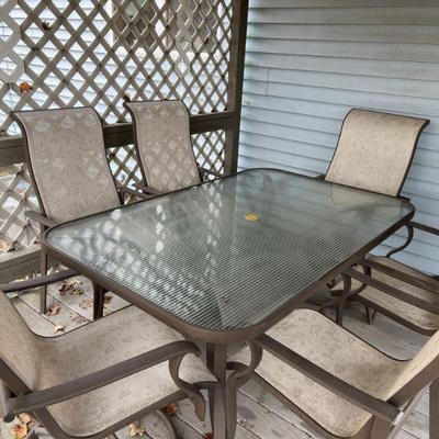 reeded glass patio dining table with six chairs