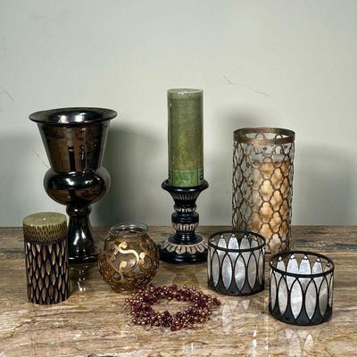 (7pc) CANDLE DECOR  |
Including votive holders, two with glass inserts appear one unscented candle with modern patterns, an Arhouse...
