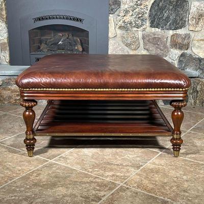 THOMASVILLE LEATHER COFFEE TABLE  |
Brown leather padded top with brass tacks, on carved wood legs with a lower open shelf - l. 40 x w....